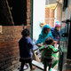 The anganwadi helper brings kids home for lunch.
